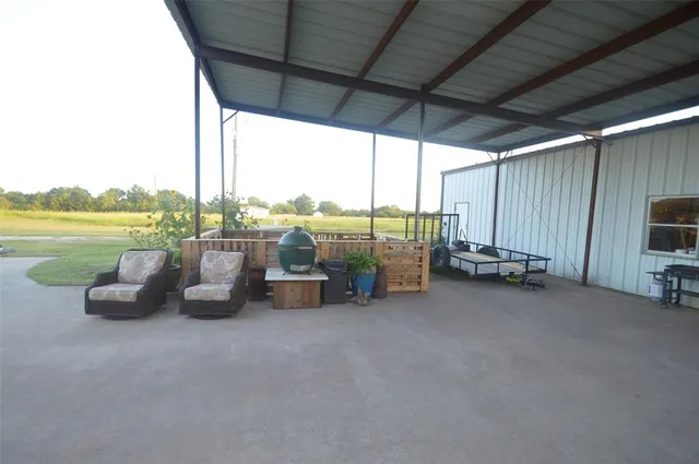 a view of a terrace with lawn chairs