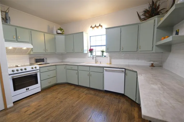 a kitchen with a white cabinets and white appliances
