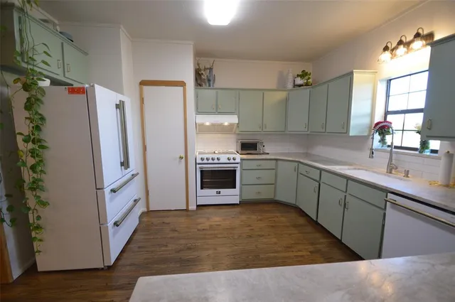 a kitchen with stainless steel appliances a refrigerator and a sink