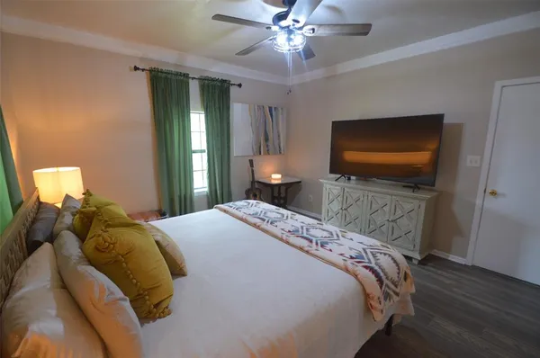 a bedroom with a bed and a flat screen tv