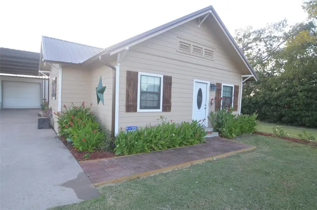 a front view of a house with garden