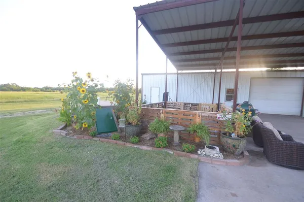 a view of a backyard with plants and a patio