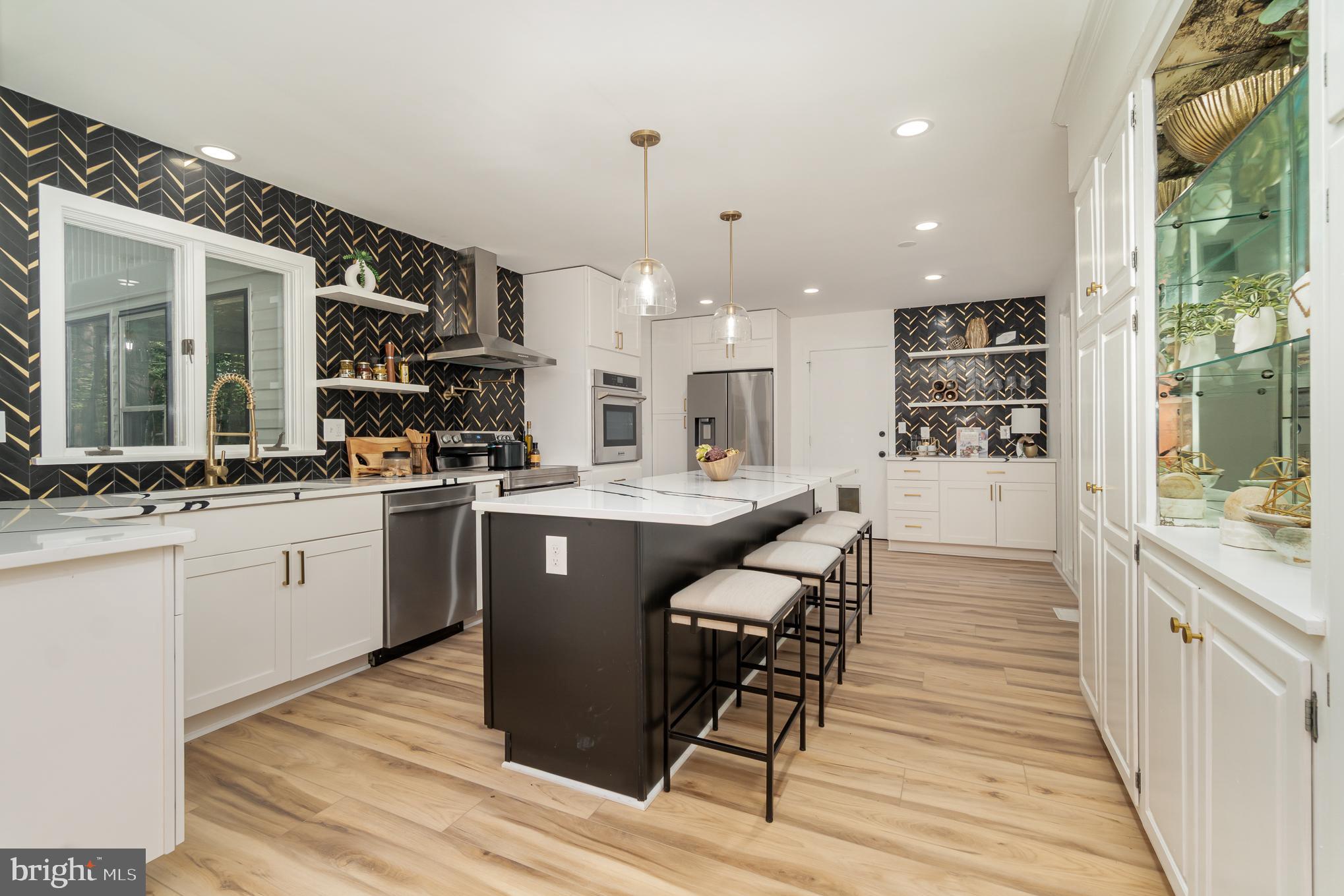 555 Hilltop Road Hummelstown, PA 17036 - Photo 21 of 56 a kitchen with a table chairs wooden floors and a view of living room