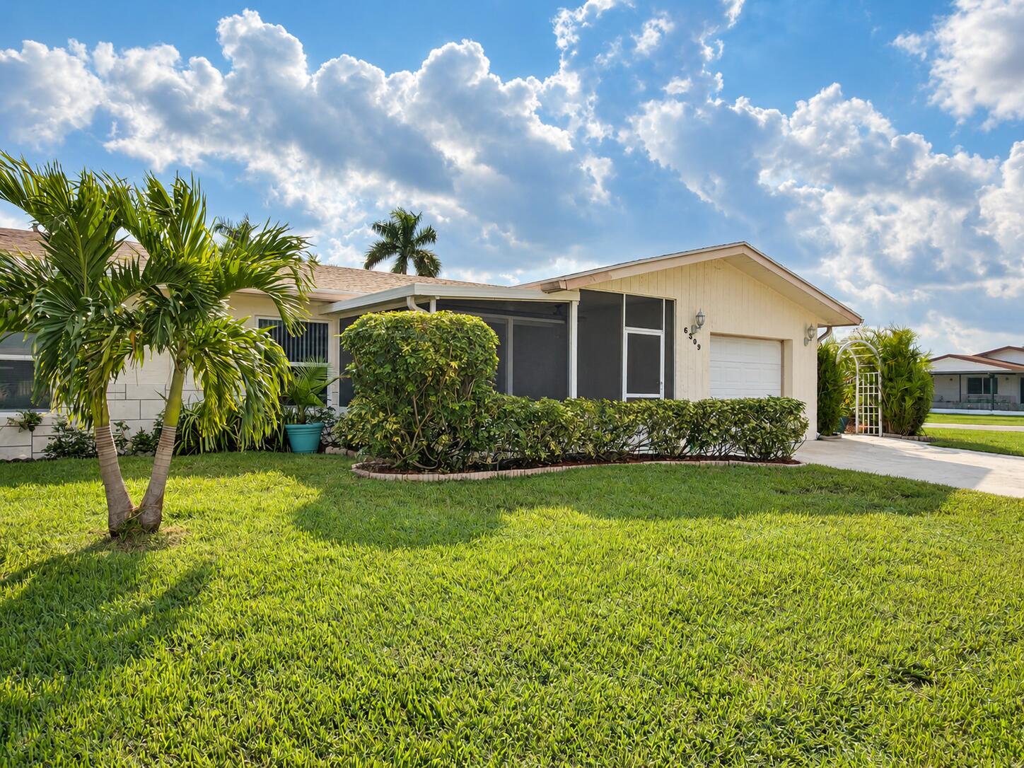 6309 Dusenburg Road Delray Beach, FL 33484 - Photo 1 of 26 Sunlit home with palms and lawn