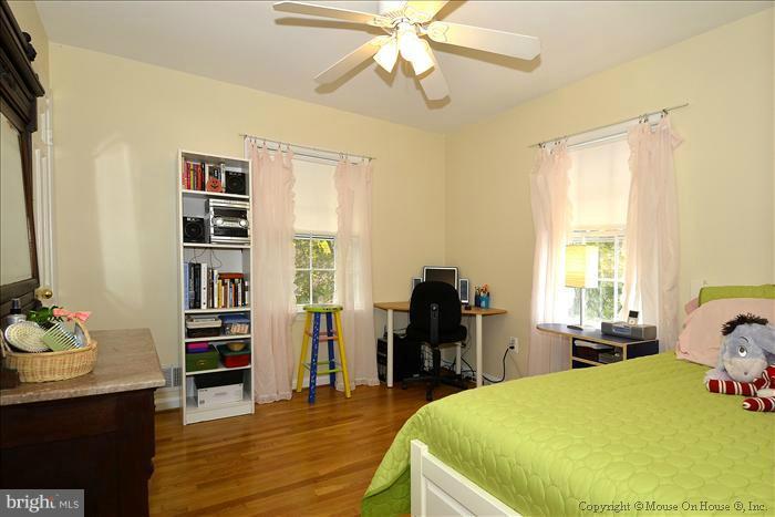 5402 Ridgefield Road Bethesda, MD 20816 - Photo 11 of 27 a bed room with a bed and a book shelf