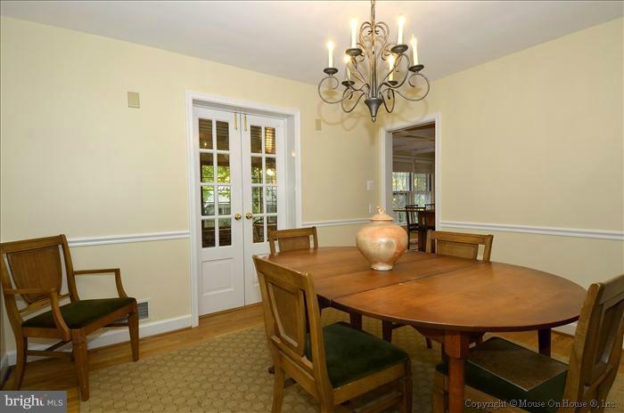 5402 Ridgefield Road Bethesda, MD 20816 - Photo 23 of 27 a view of a dining room with furniture and chandelier