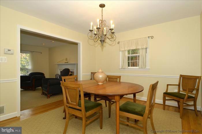 5402 Ridgefield Road Bethesda, MD 20816 - Photo 25 of 27 a view of a dining room with furniture and a chandelier