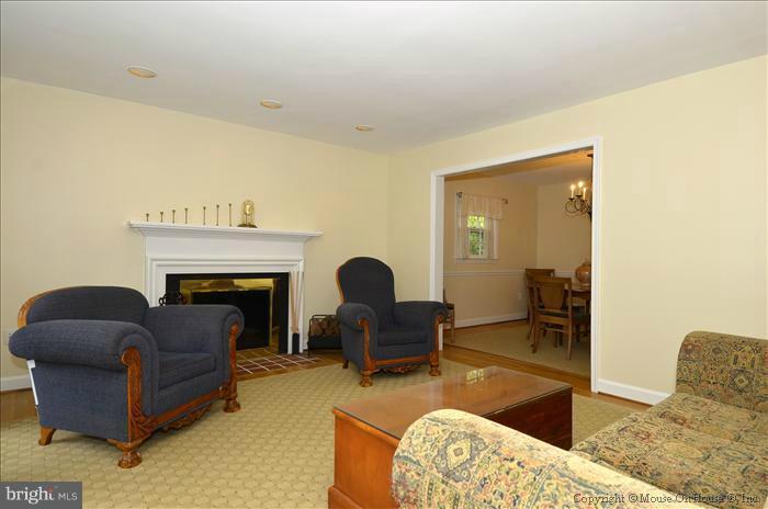 5402 Ridgefield Road Bethesda, MD 20816 - Photo 26 of 27 a living room with furniture and a fireplace