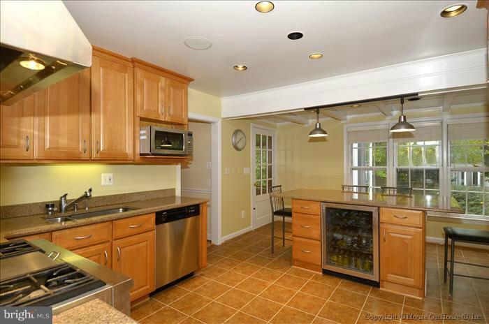 5402 Ridgefield Road Bethesda, MD 20816 - Photo 6 of 27 a kitchen with stainless steel appliances granite countertop a sink and cabinets