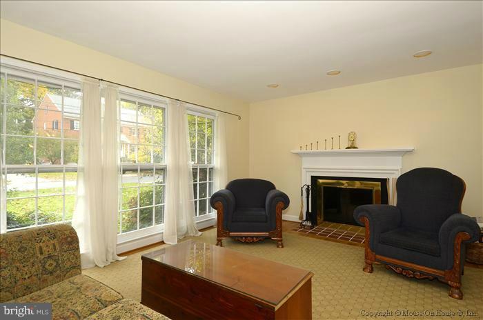 5402 Ridgefield Road Bethesda, MD 20816 - Photo 7 of 27 a living room with furniture and a fireplace