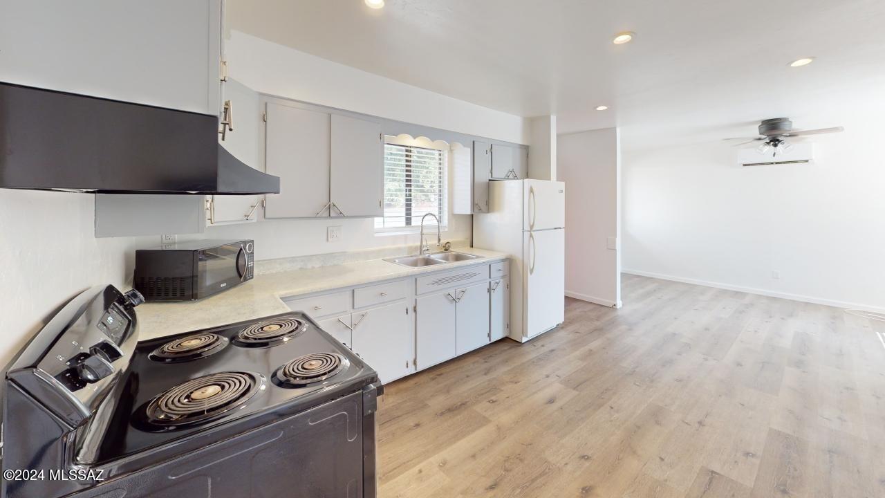 2118 North Rita Avenue Tucson, AZ 85716 - Photo 2 of 17 a kitchen with a sink a stove and cabinets