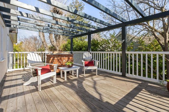a deck with wooden floor and outdoor seating