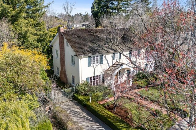 a view of a house with a tree