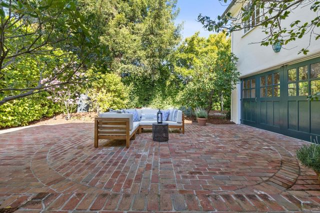 a backyard of a house with table and chairs