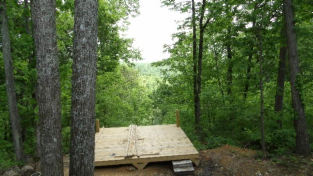 837 Rock Springs Road Celina, TN 38551 - Photo 16 of 28 a wooden bench sitting in the middle of a forest