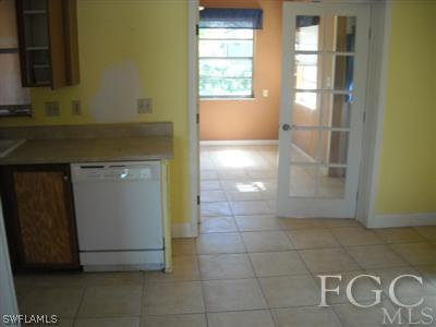 18549 Sunflower Road Fort Myers, FL 33967 - Photo 3 of 5 a view of a refrigerator in kitchen and wooden floor