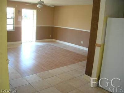 18549 Sunflower Road Fort Myers, FL 33967 - Photo 5 of 5 an empty room with wooden floor and windows