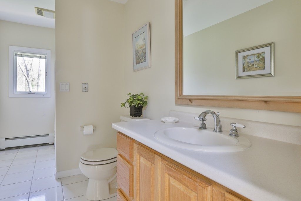 93 Beach Road Salisbury, MA 01952 - Photo 28 of 30 a bathroom with a sink toilet and vanity
