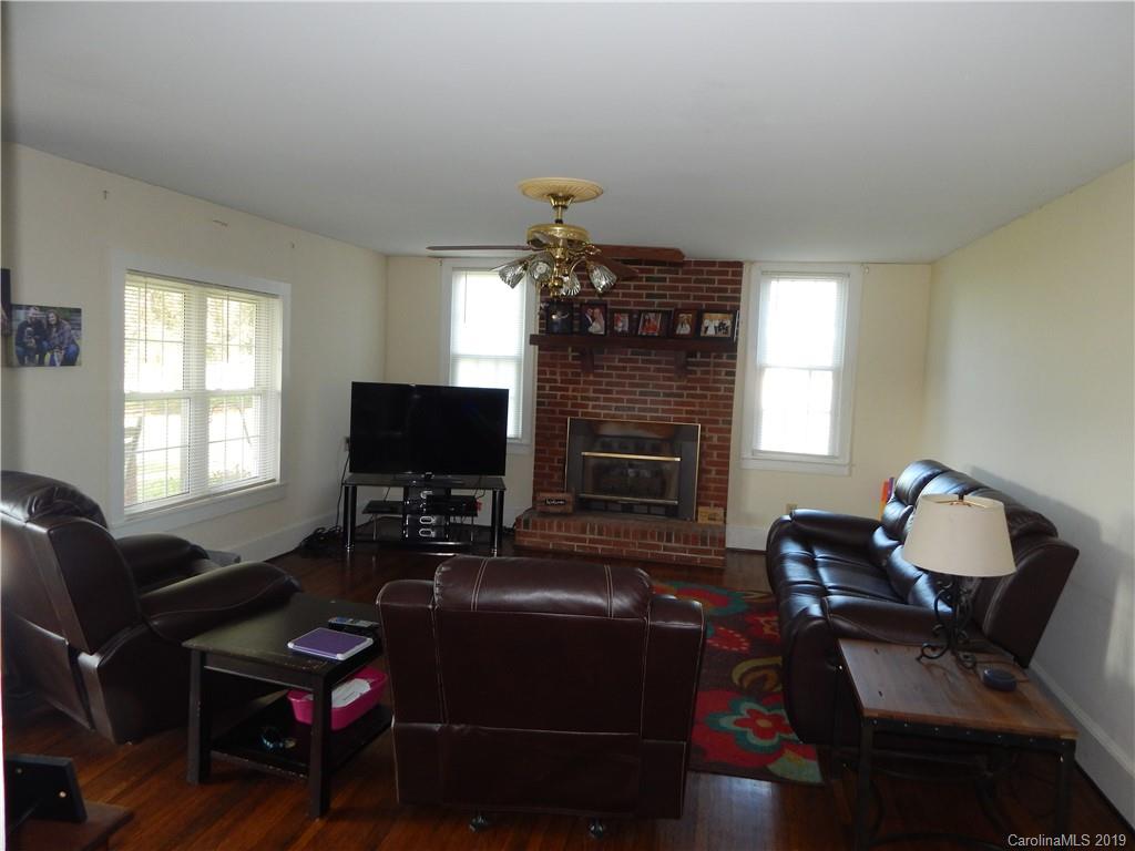 387 Bennett Martin Road Polkton, NC 28135 - Photo 14 of 24 a living room with furniture a fireplace and a flat screen tv