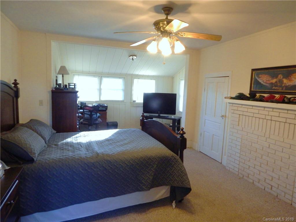 387 Bennett Martin Road Polkton, NC 28135 - Photo 22 of 24 a bedroom with a bed and a flat screen tv