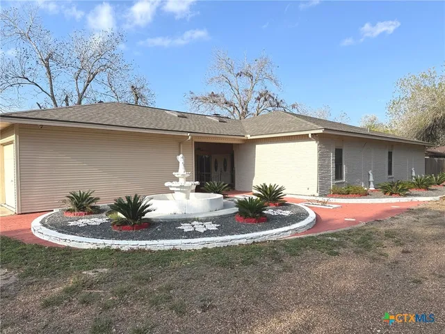a front view of house with yard and garage
