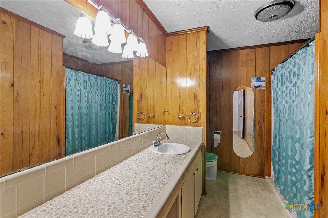 608 Berwick Road Victoria, TX 77904 - Photo 20 of 31 a bathroom with a granite countertop sink and a mirror