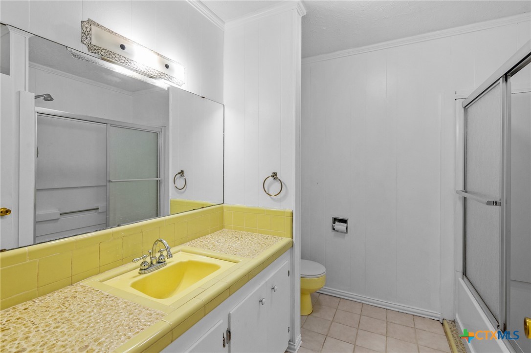 608 Berwick Road Victoria, TX 77904 - Photo 22 of 31 a bathroom with a granite countertop sink and a mirror