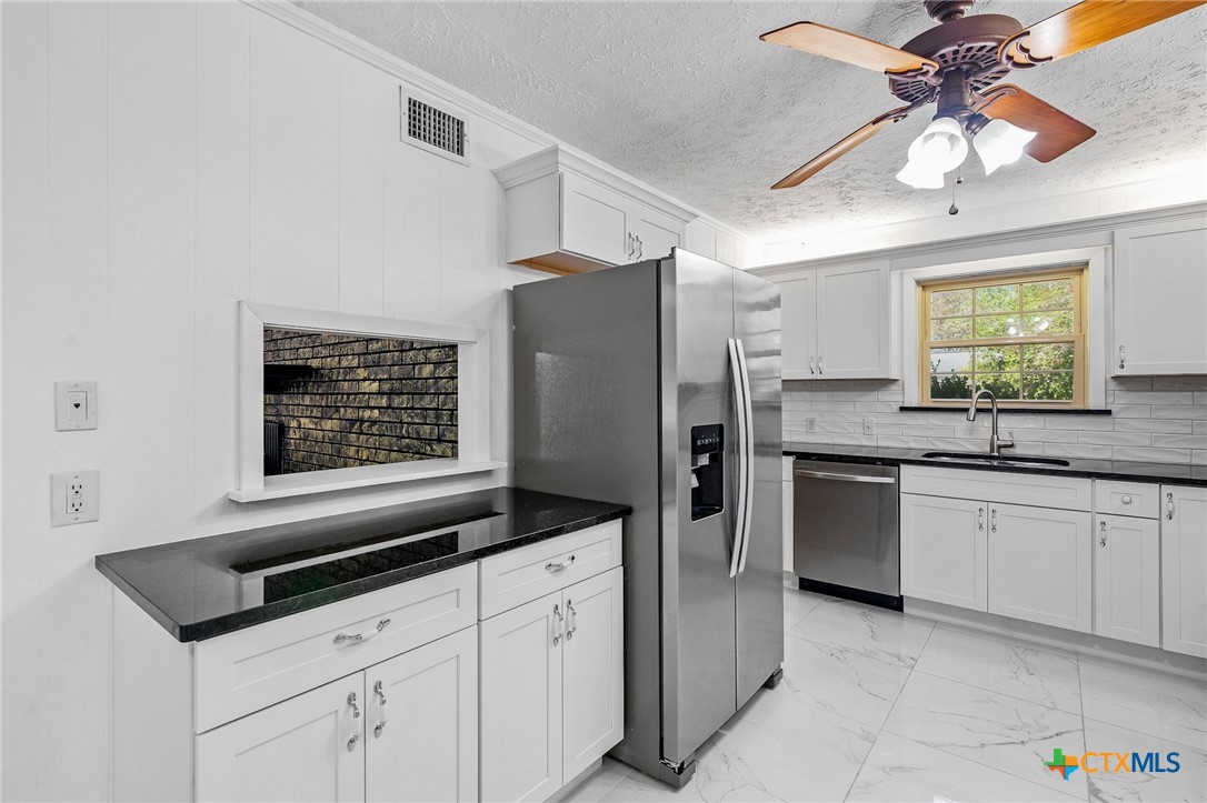 608 Berwick Road Victoria, TX 77904 - Photo 3 of 31 a kitchen with granite countertop cabinets and steel stainless steel appliances