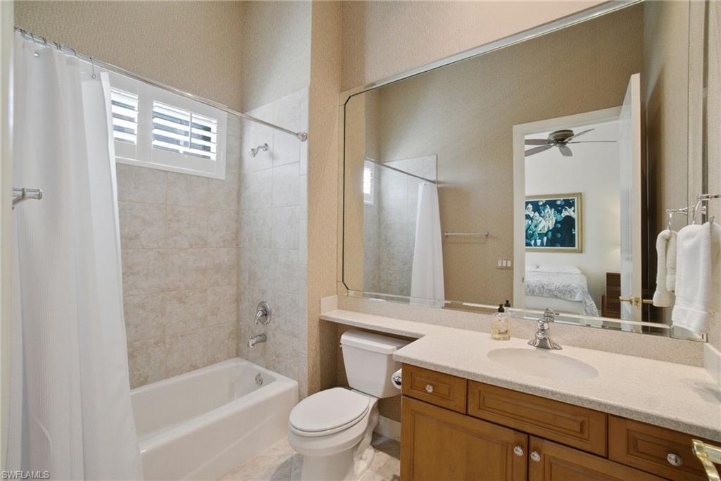 17015 Porta Vecchio Way, Unit 101 Naples, FL 34110 - Photo 19 of 39 a bathroom with a sink a toilet and shower