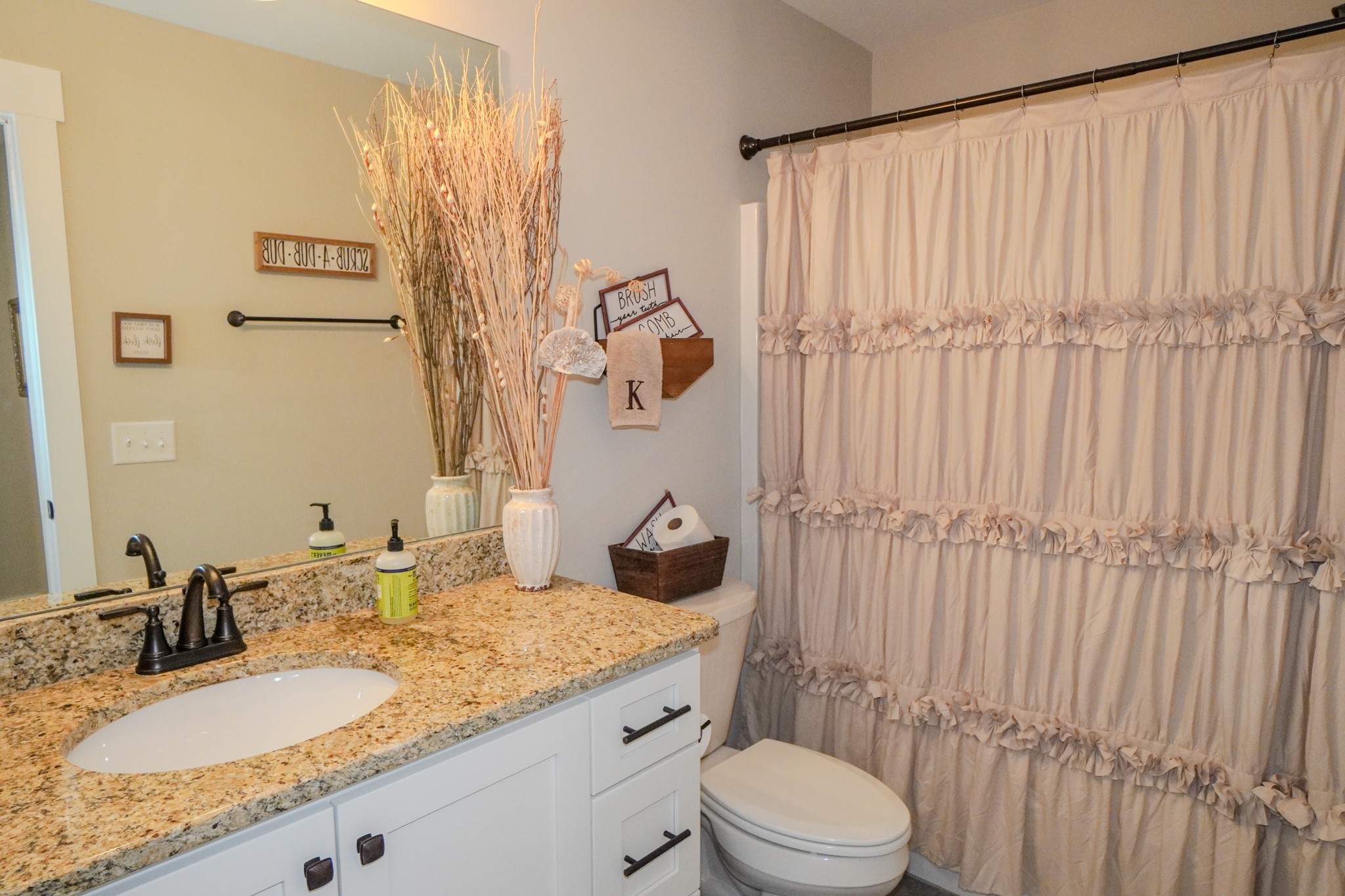 529 Clearview Road Cottontown, TN 37048 - Photo 40 of 64 a bathroom with a granite countertop sink and a mirror