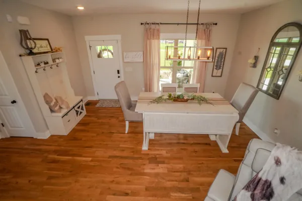 a living room with furniture and a chandelier