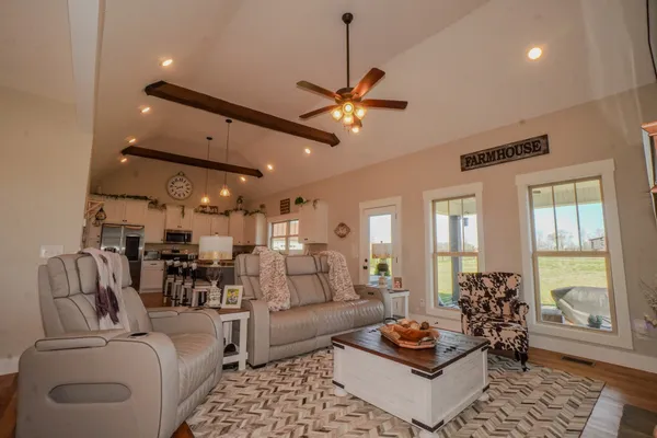 a kitchen with stainless steel appliances granite countertop a sink a stove and a wooden floors