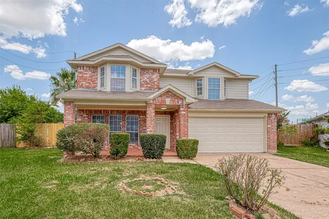 a front view of a house with a garden and plants