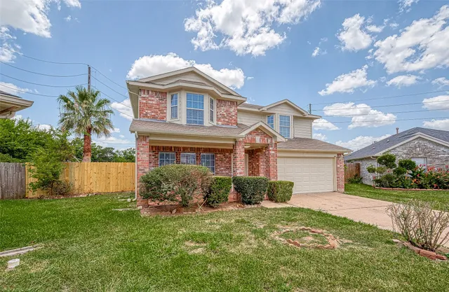 a front view of a house with a garden and plants