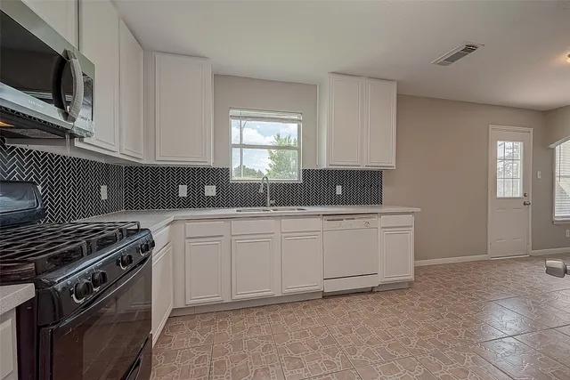 a kitchen with stainless steel appliances a refrigerator and a sink