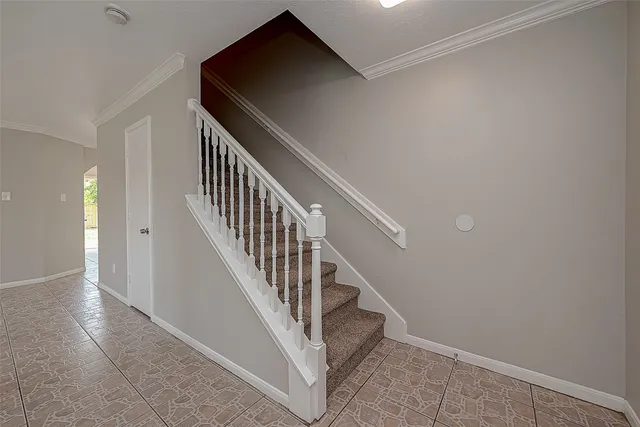 an empty room with windows and ceiling fan