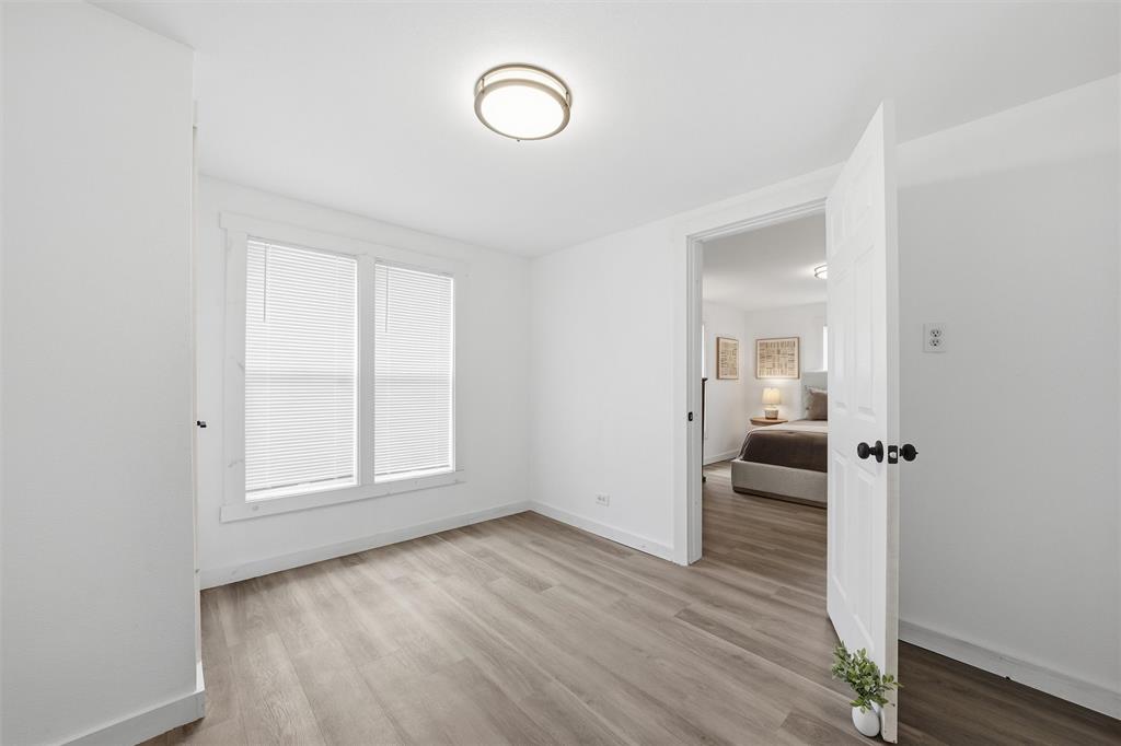 1116 Houston Street Waco, TX 76704 - Photo 11 of 16 wooden floor in an empty room with a window