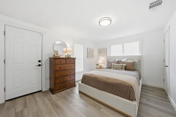 a bedroom with a bed and a dresser