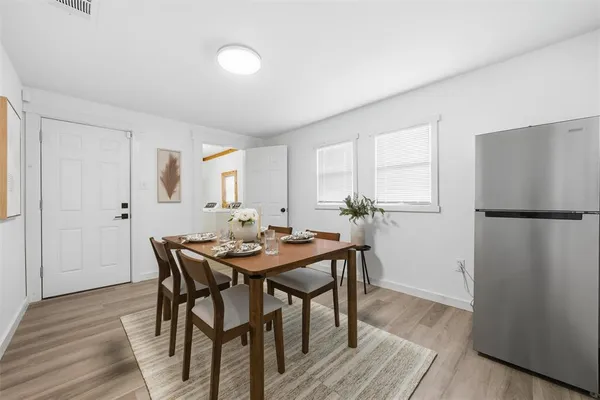 a view of a dining room with furniture and wooden floor