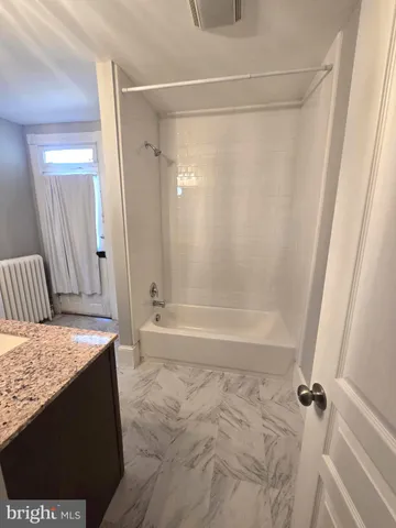 a bedroom with a baby bed and a window