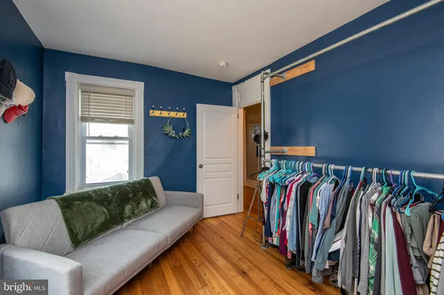 a bedroom with a bed a flat tv screen and a window