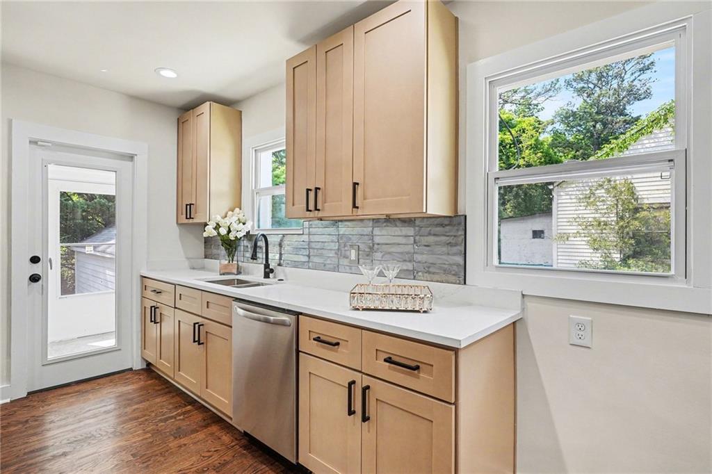 1275 Westridge Road Southwest Atlanta, GA 30311 - Photo 10 of 34 a kitchen with stainless steel appliances granite countertop a sink stove and cabinets