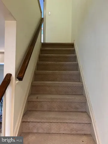 a view of a room with wooden floor and a window