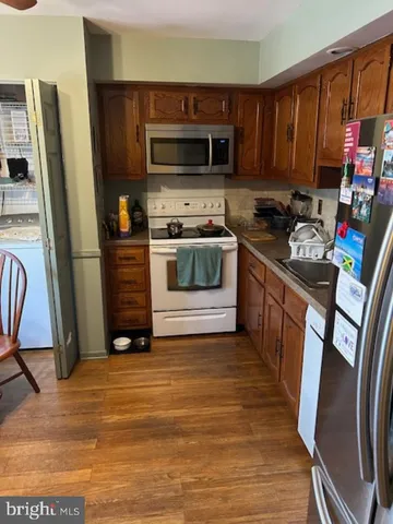 a kitchen with stainless steel appliances a stove a refrigerator and a refrigerator