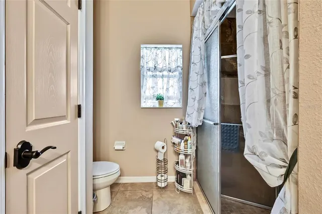 a bathroom with a toilet sink and shower