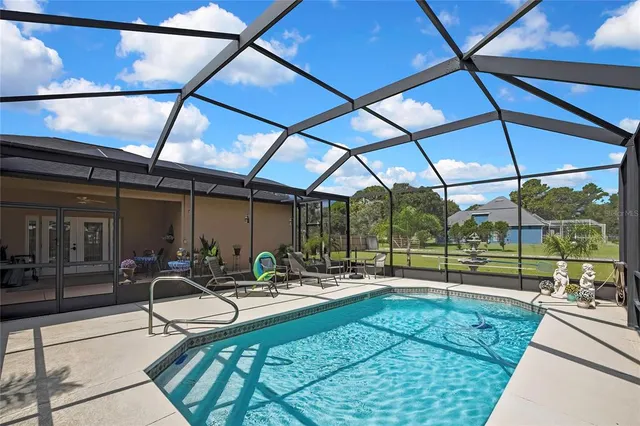a view of a house with a backyard porch and sitting area