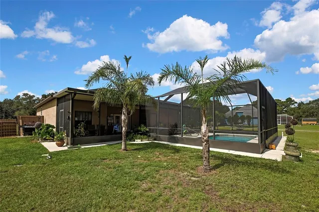 a view of a house with a backyard