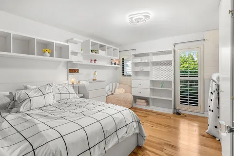 a bedroom with a bed and a window