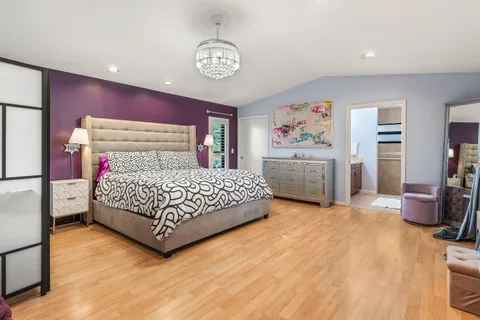 a bedroom with a bed and a chandelier