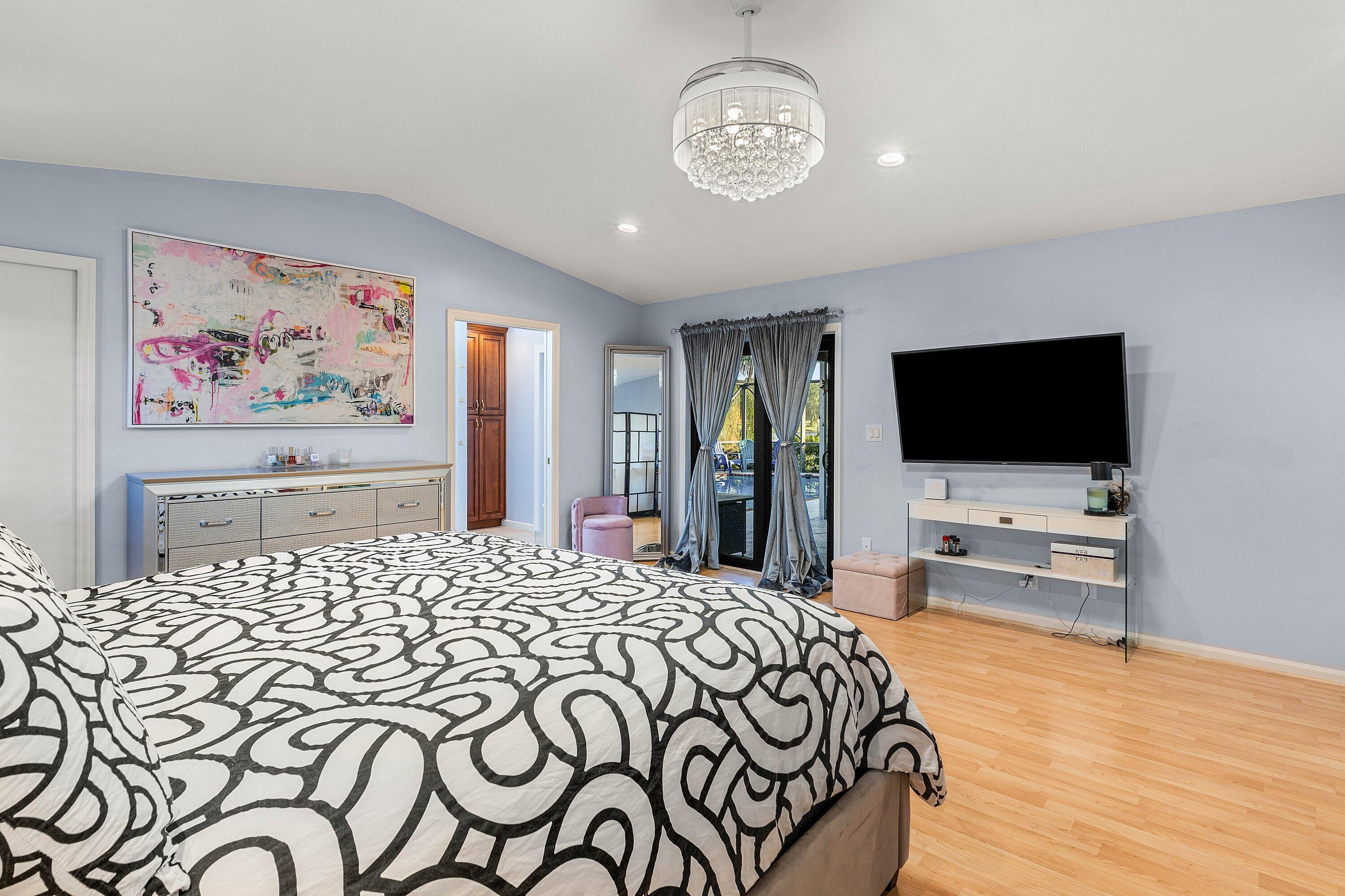 10174 Crosswind Road Boca Raton, FL 33498 - Photo 19 of 45 a bedroom with a bed and a flat screen tv